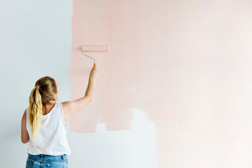 Girl painting a wall