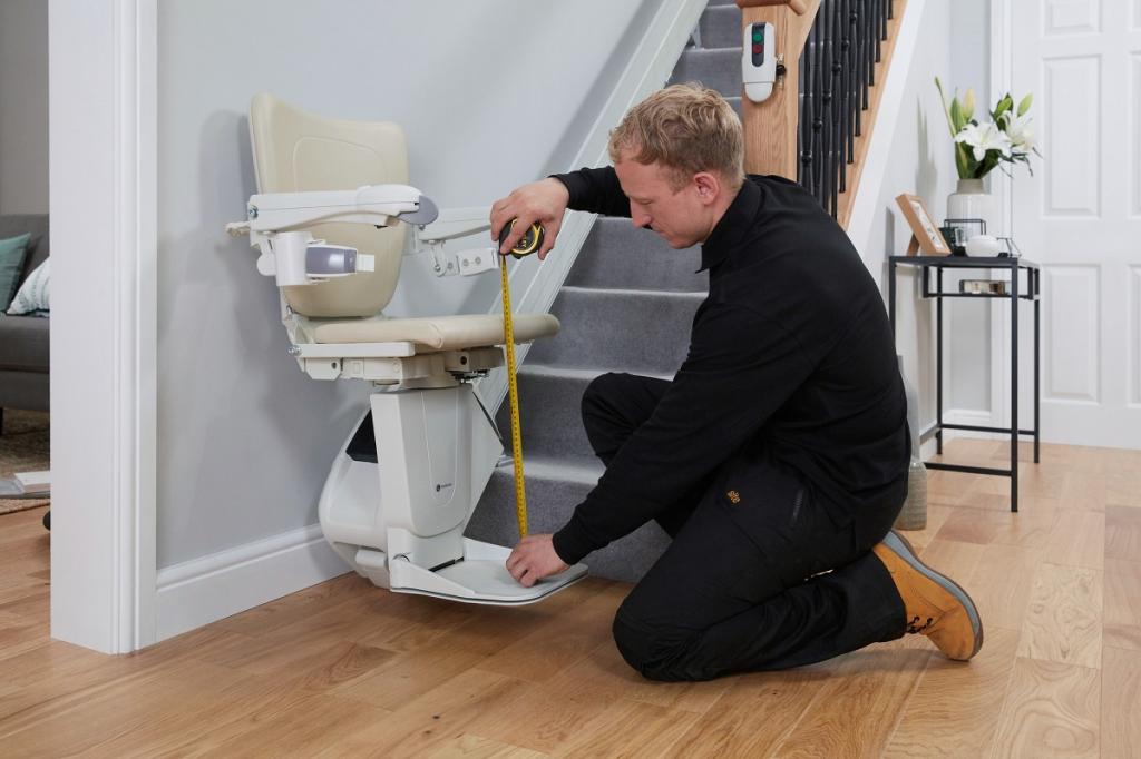 Handicare expert installing Age uk stairlift