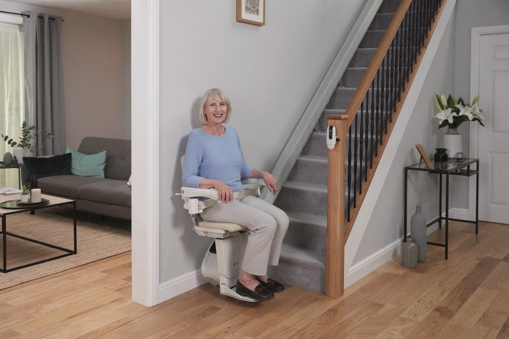women using age uk straight stairlift