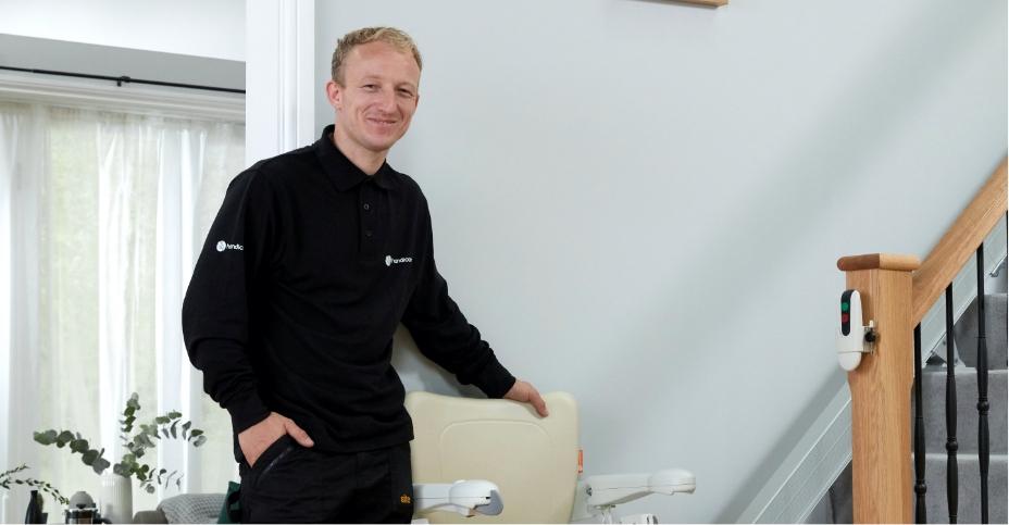 Stairlift engineer standing next to a stairlift